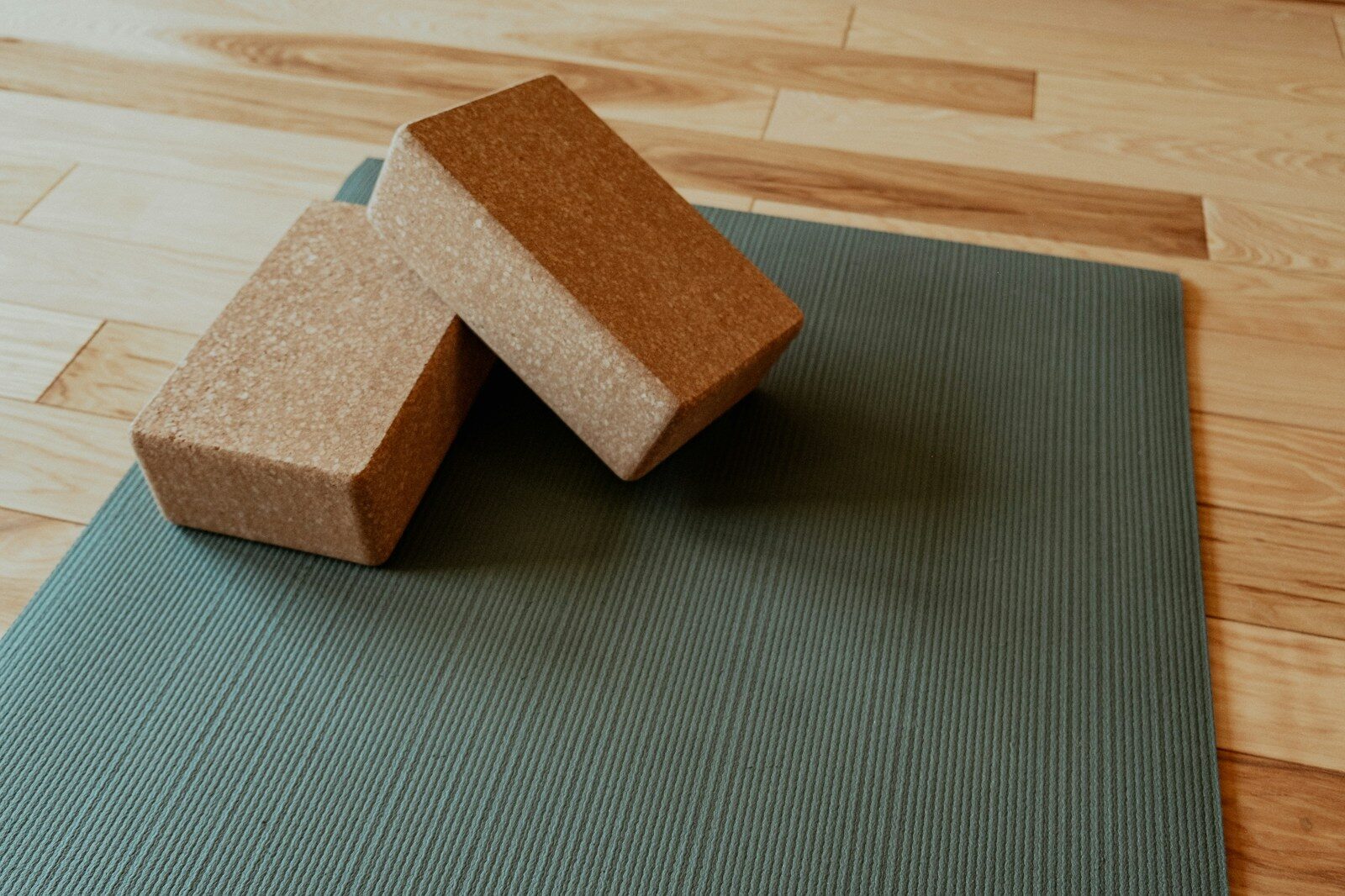 Photo by Samantha Sheppard a yoga mat with two blocks on top of it